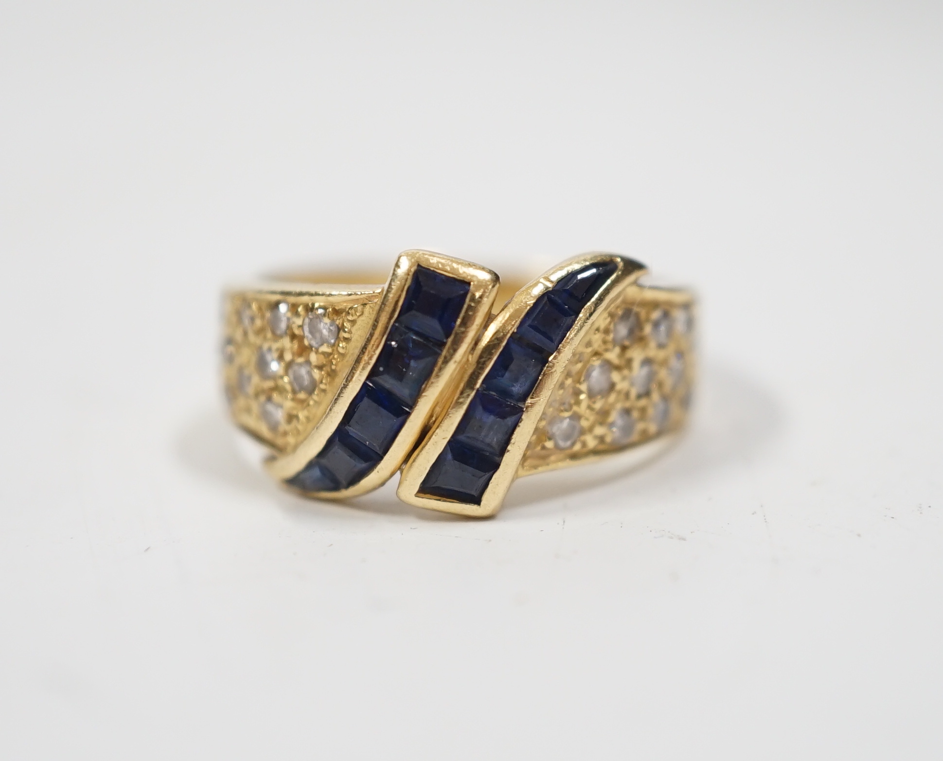 A modern 750 yellow metal, sapphire and diamond chip set dress ring, size K, gross weight 4.8 grams.